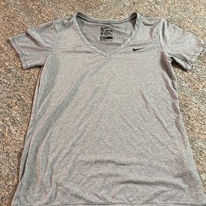 Nike dry fit athletic top. No stains or spots. Worn twice, grey/white striped S